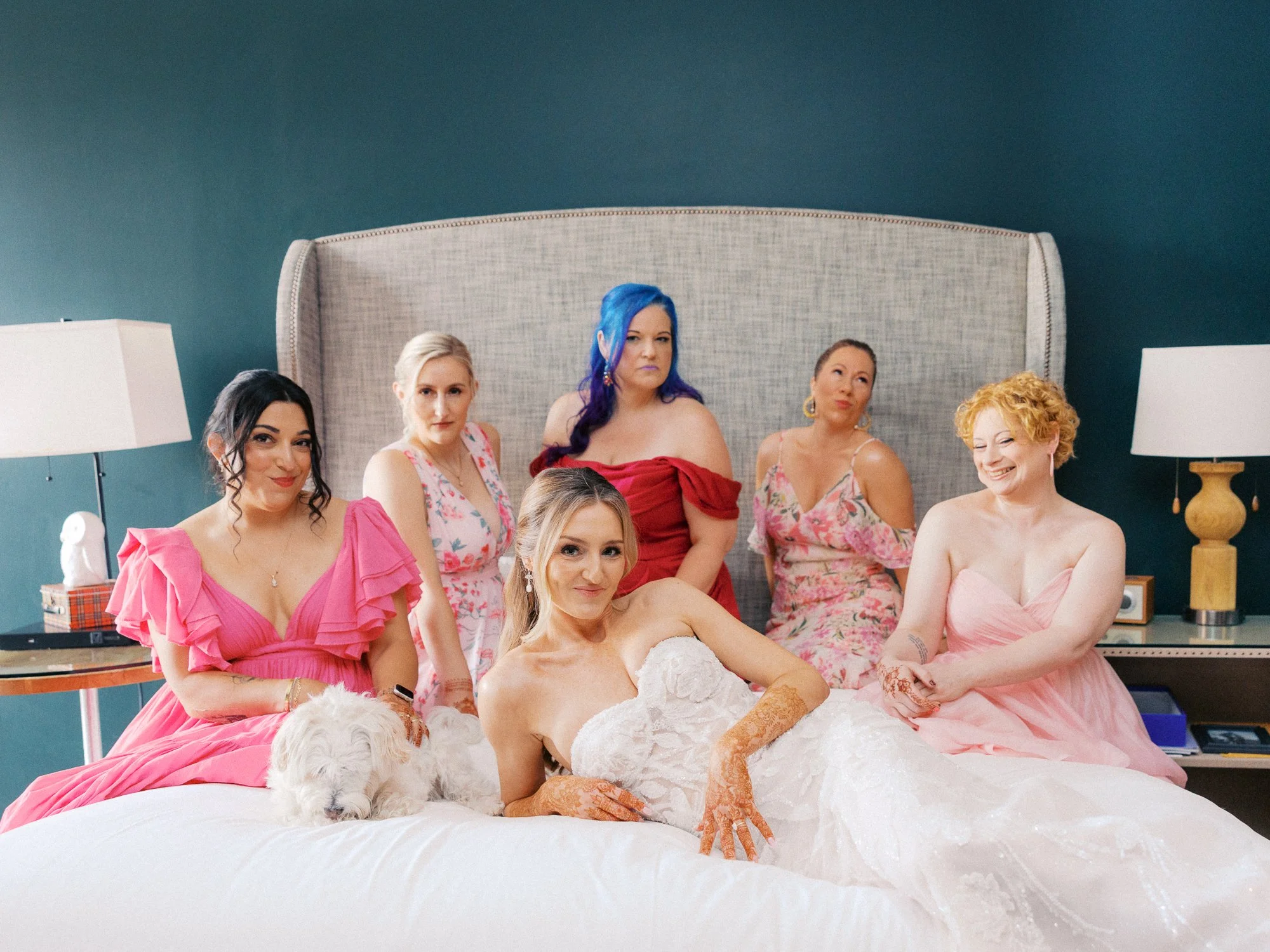 Alacia and her wedding party gathered on the bed before the ceremony at Portland’s Sentinel Hotel.