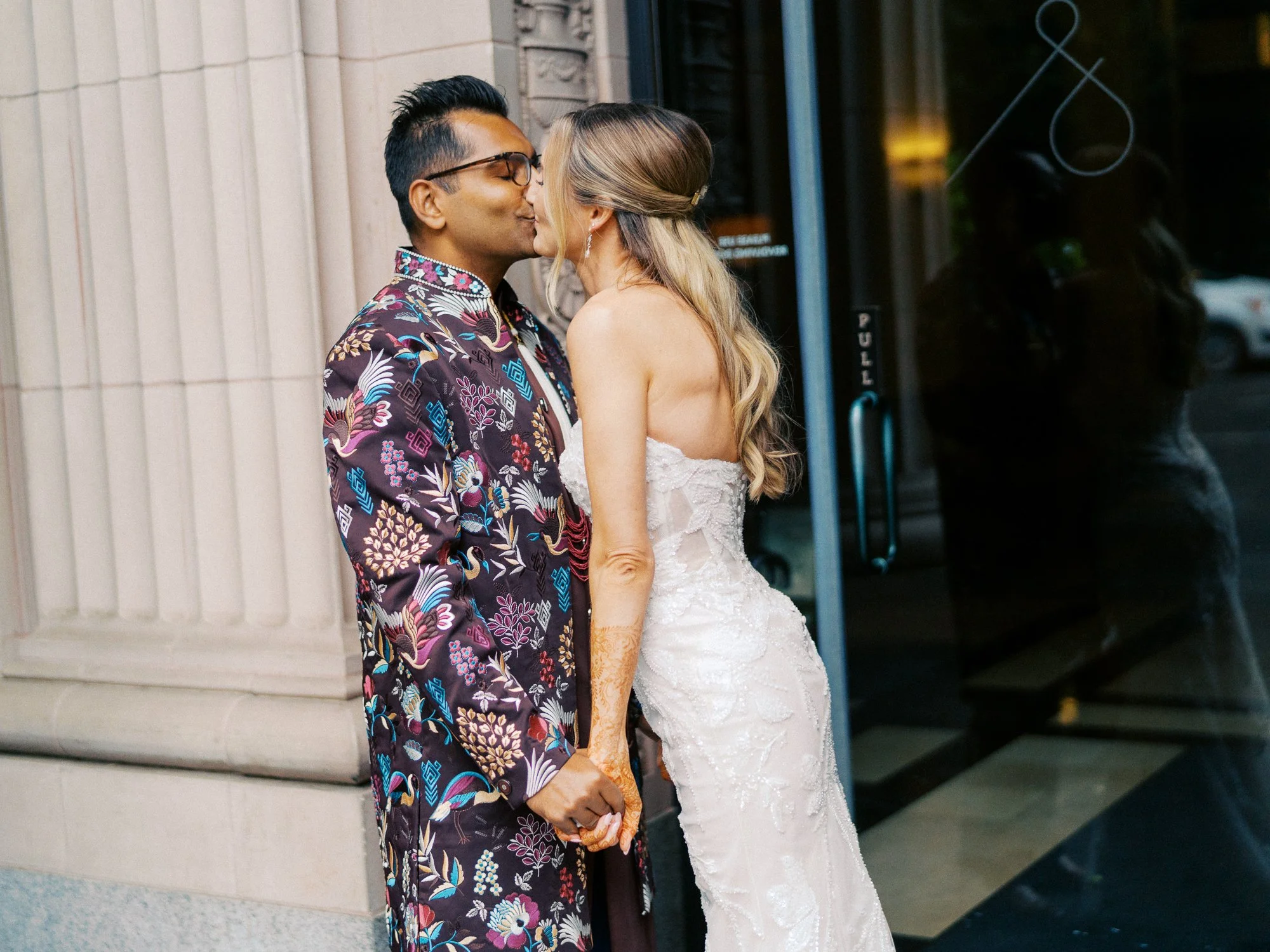 Bride and groom kiss outside the hotel after their first look.
