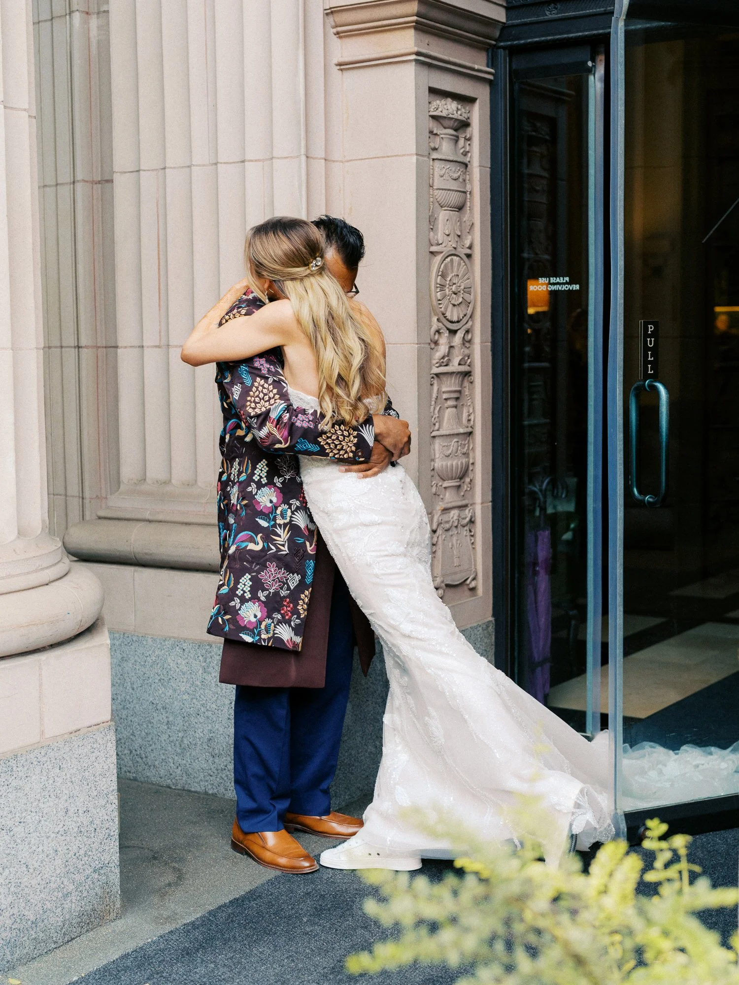 Bride and groom embrace outside the Sentinel Hotel before their Portland wedding celebration.