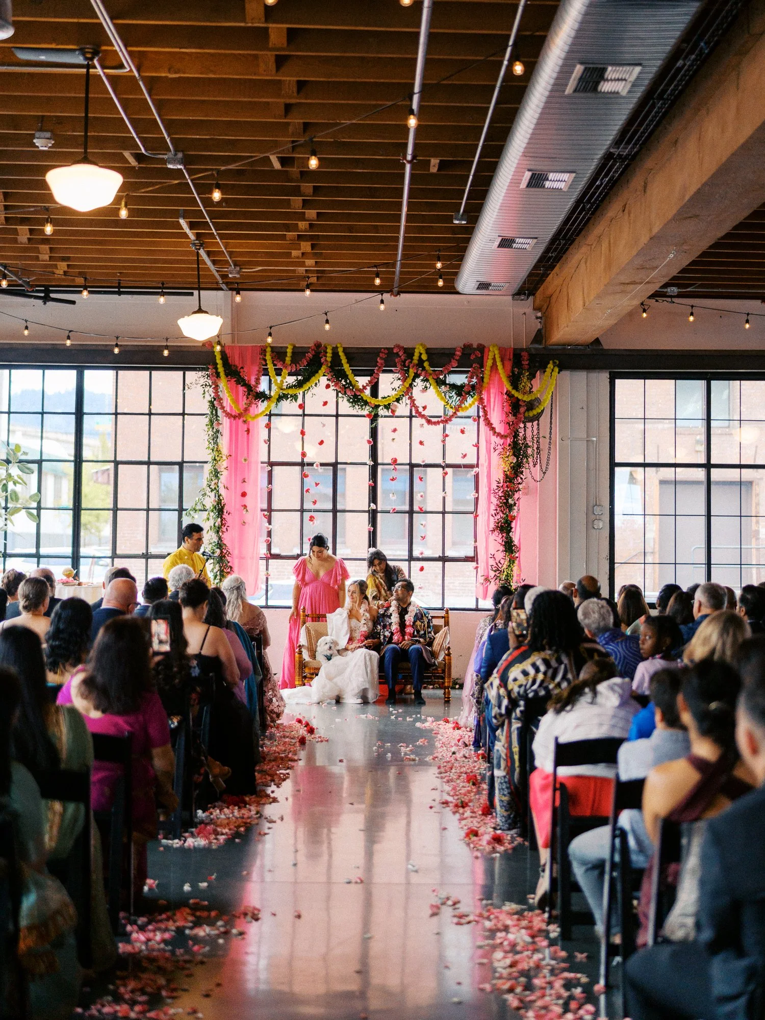 Wide view of the Castaway Portland ceremony with guests lining a petal-covered aisle.