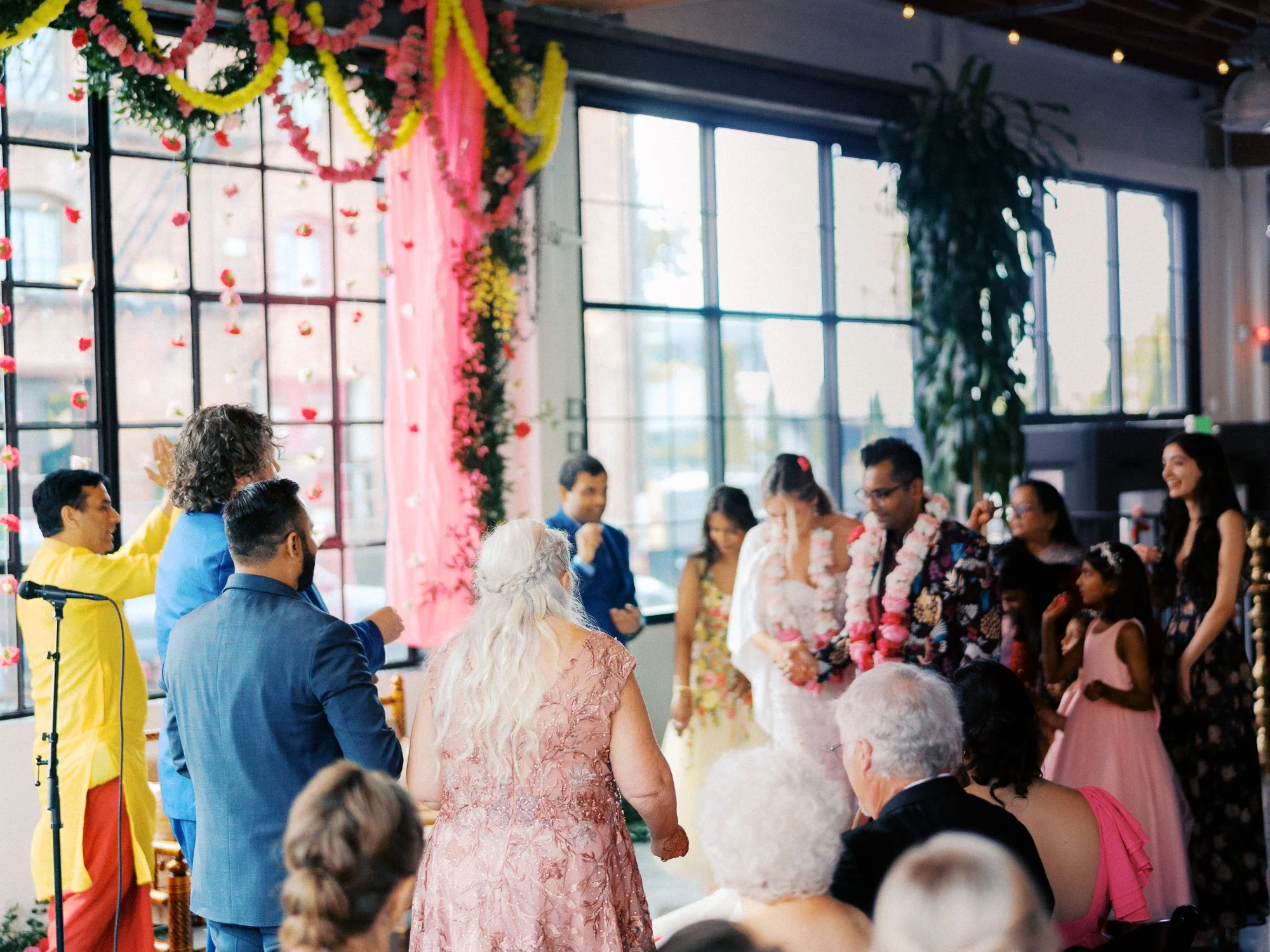 Guests and family gather around the couple during a wedding ritual inside Castaway Portland.