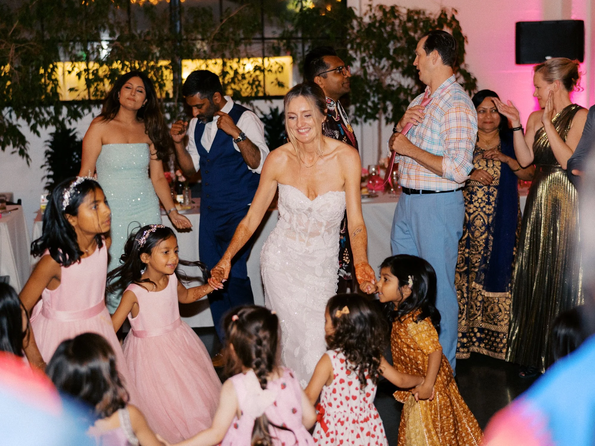 Bride dances hand in hand with children during the wedding reception at Castaway Portland.