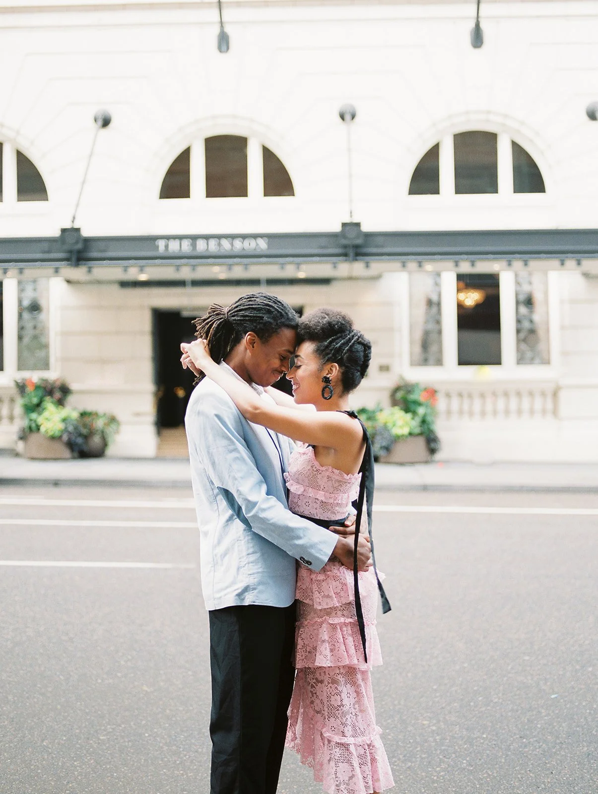 Couple hugging in the street outside The Benson Hotel in downtown Portland