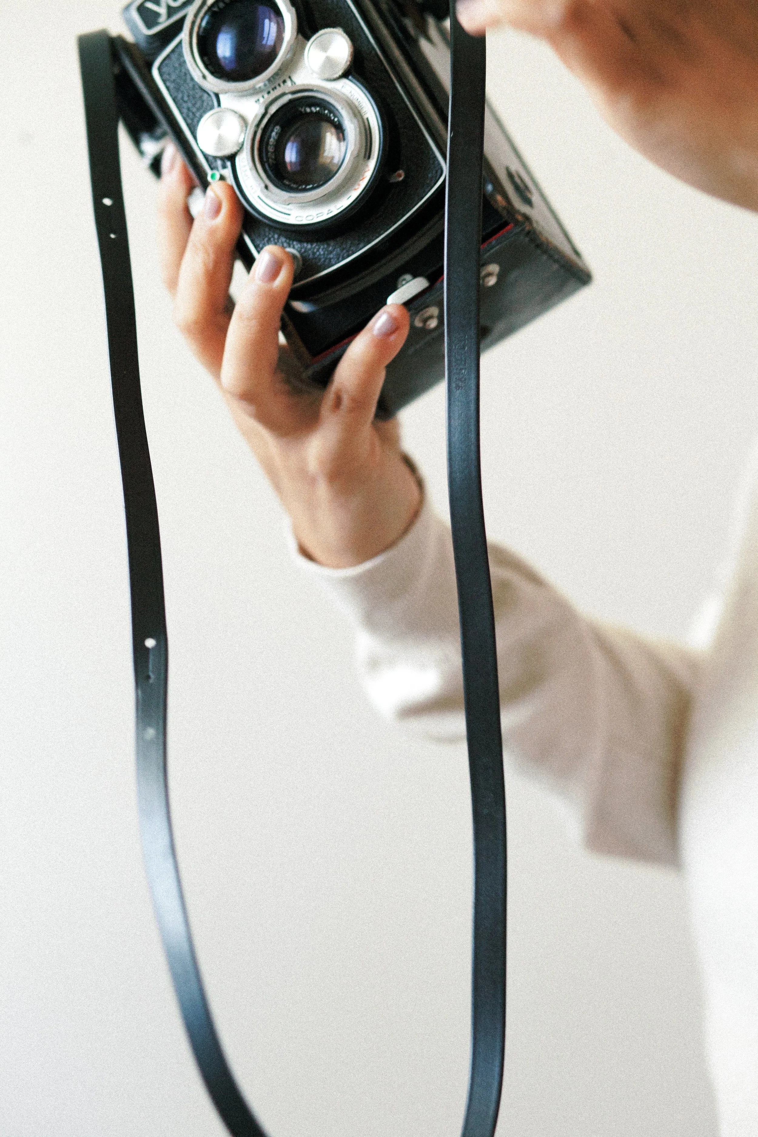 Vintage film camera reflected within an ornate mirror frame.