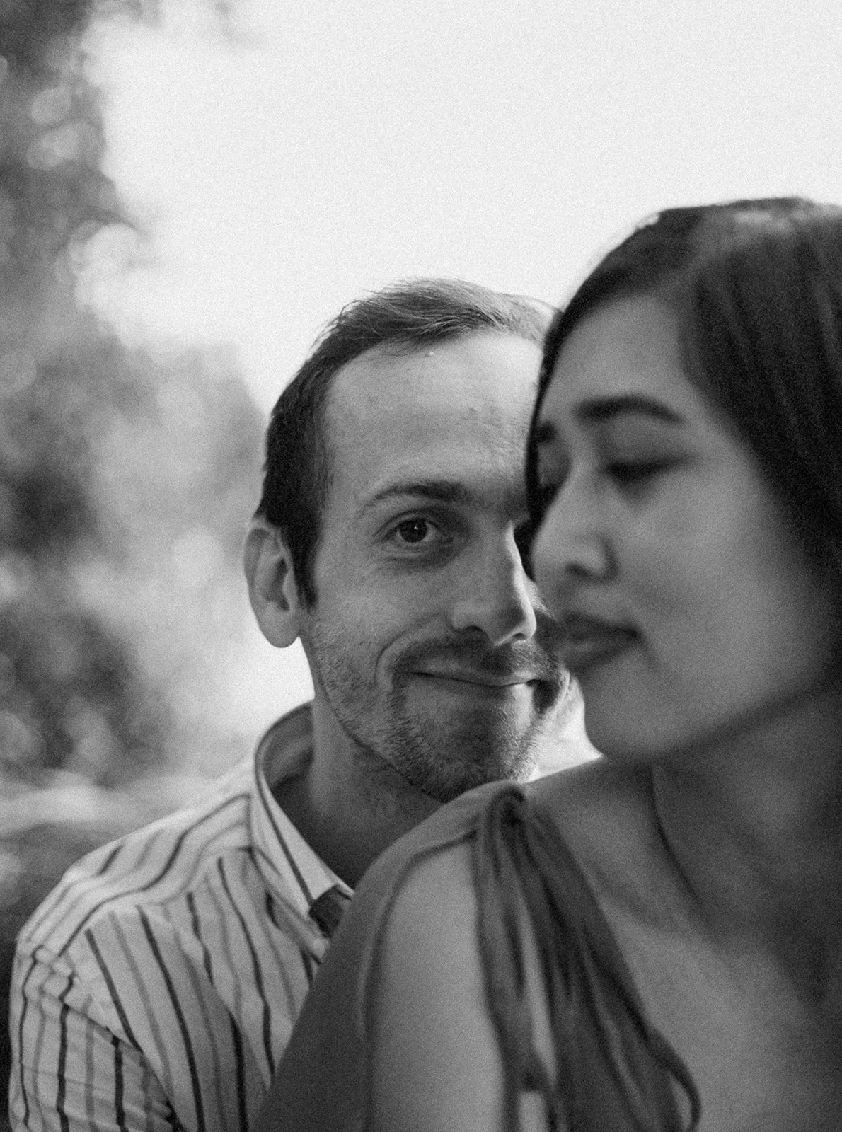 Playful candid of couple laughing together near the water during Oregon engagement photos