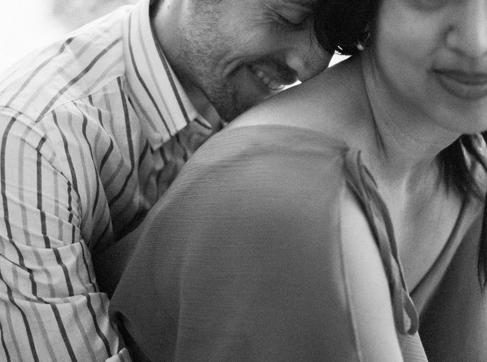 Close-up of couple embracing, candid moment during lakeside Oregon engagement session