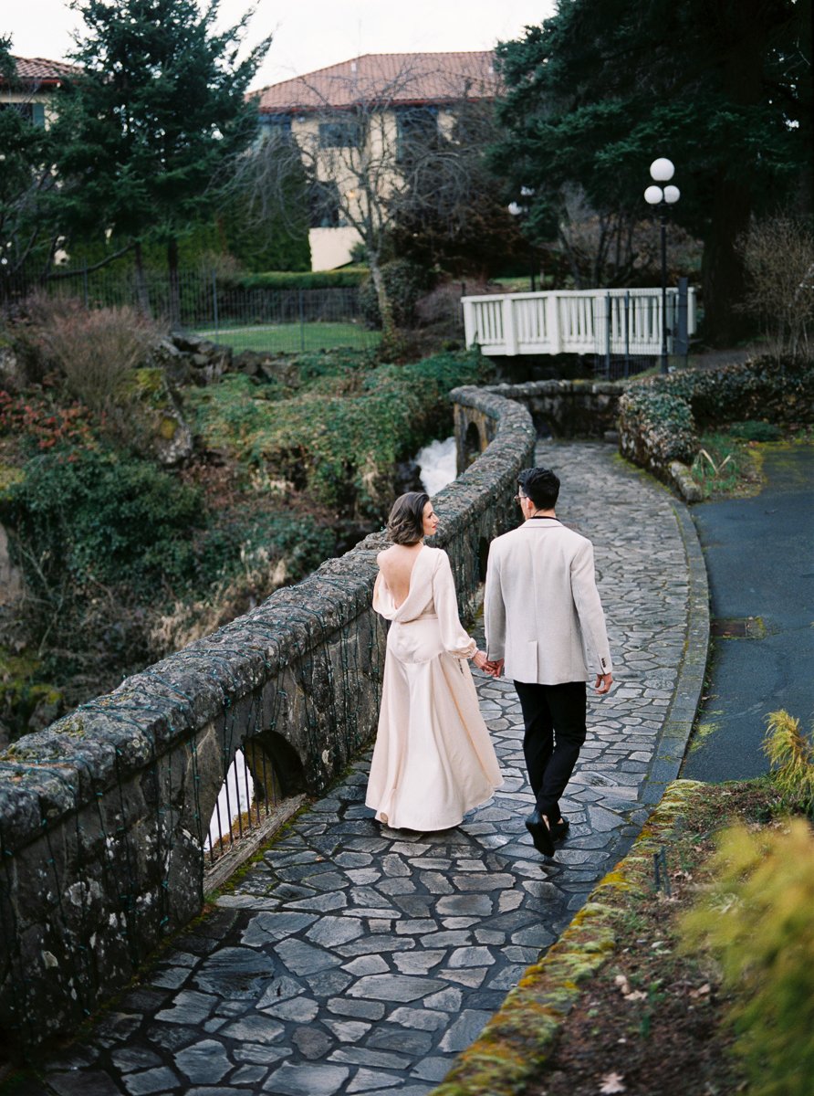 Couple walking along curved stone pathway at Columbia Gorge Hotel in Hood River