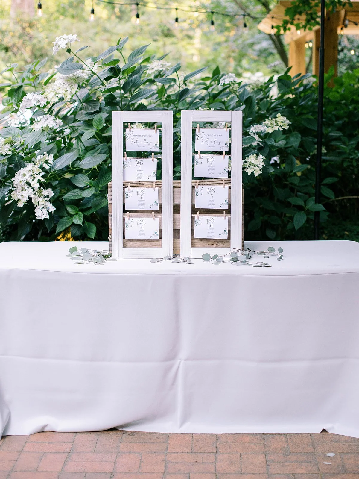 Seating chart on a table in front of greenery at Leach Botanical Gardens