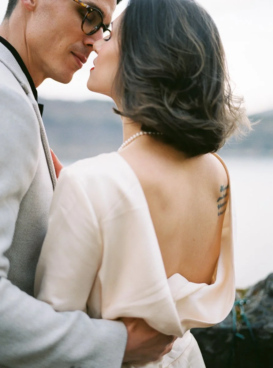 Couple embracing at the Columbia Gorge Hotel overlook, photographed on film with soft light, river views, and an intimate editorial feel.