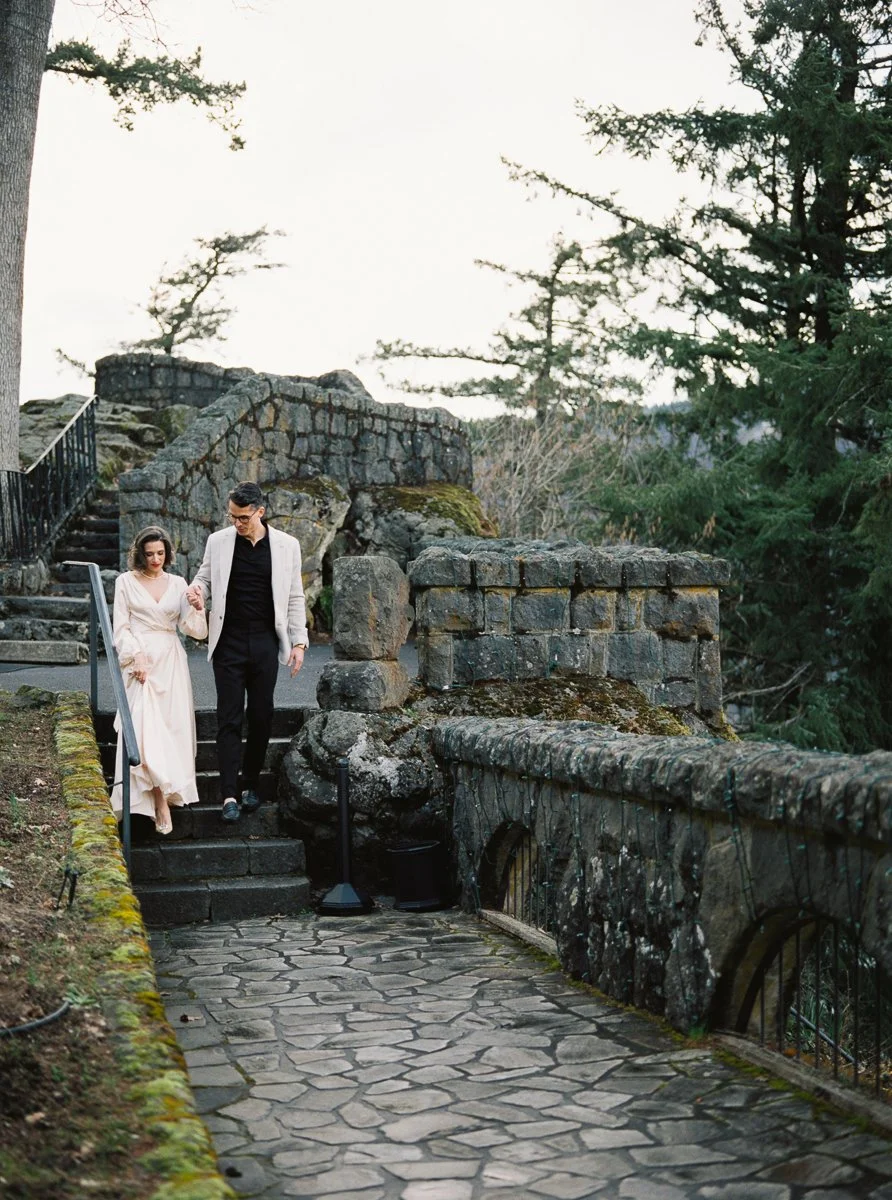 Couple walking down stone steps surrounded by greenery at Columbia Gorge Hotel