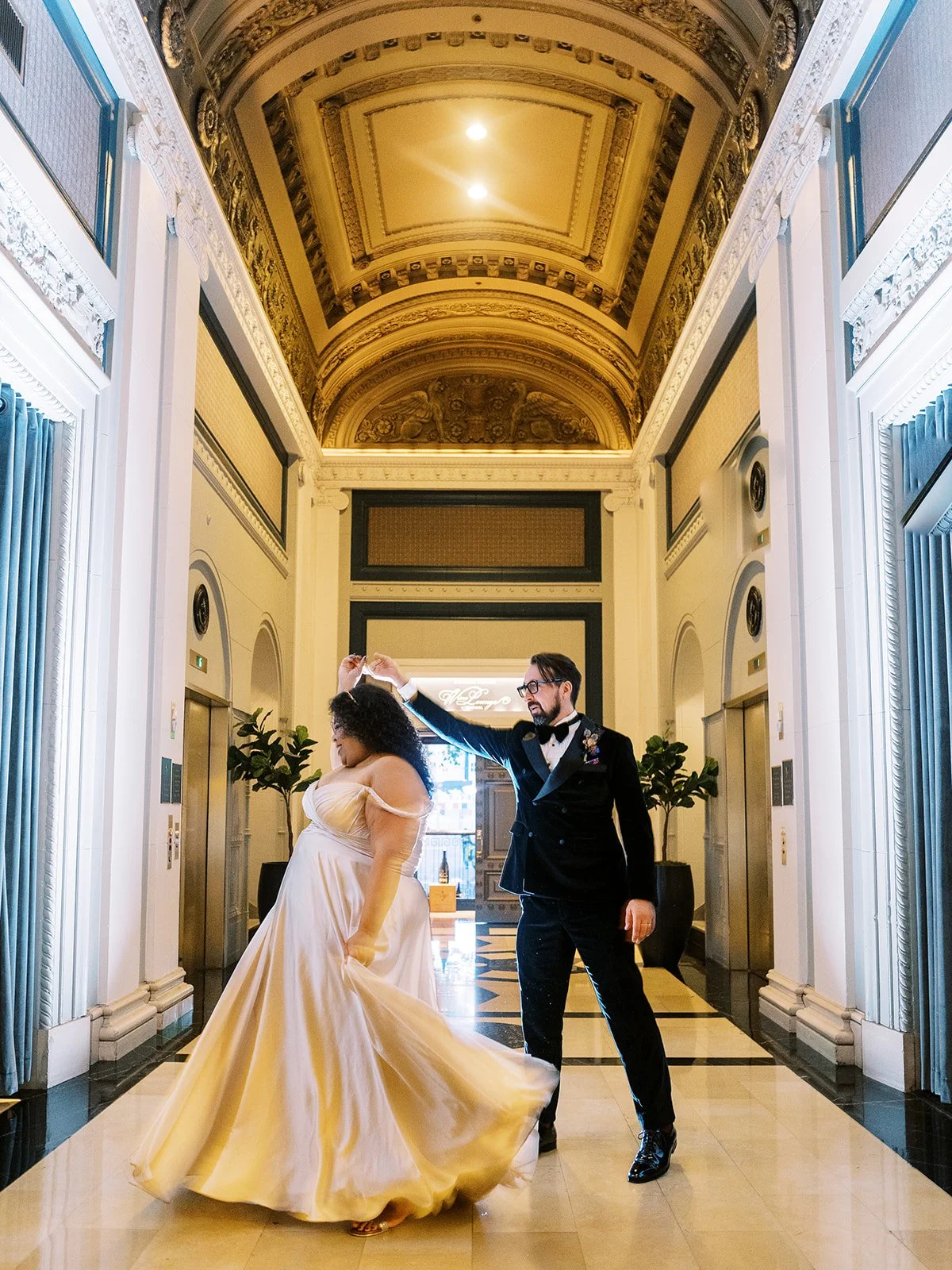 Couple dancing beneath ornate historic ceiling and marble floor in the Sentinel Hotel lobby during a Portland wedding.