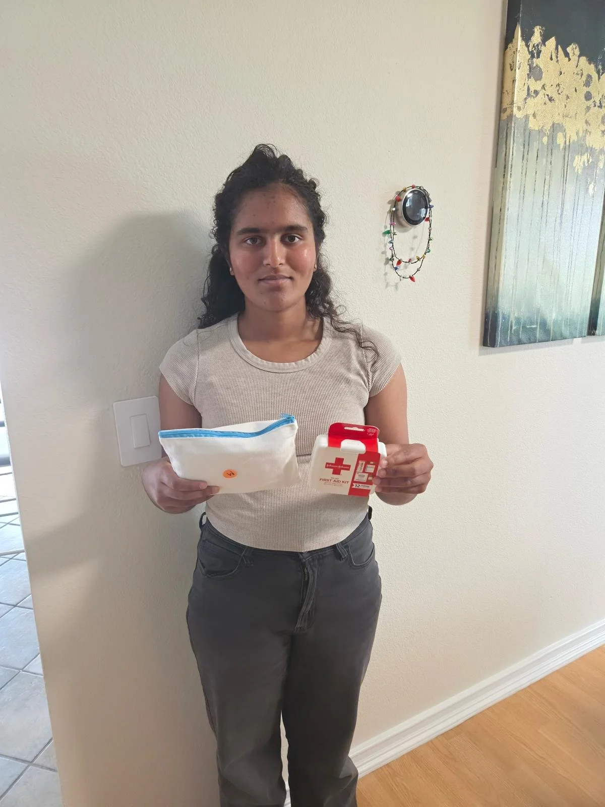 Youth volunteer packing first aid kits for girls. Also delivered to shelters.