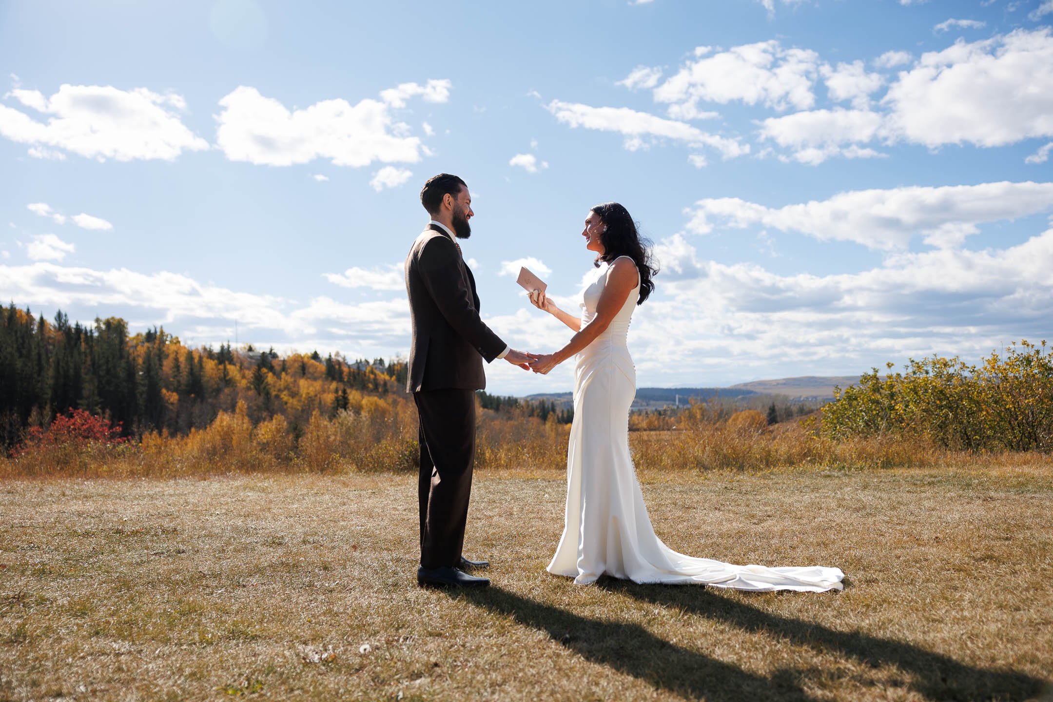 A wedding couple standing outside in a field holding hands during a wedding coordinated by Neesa and Co Events.