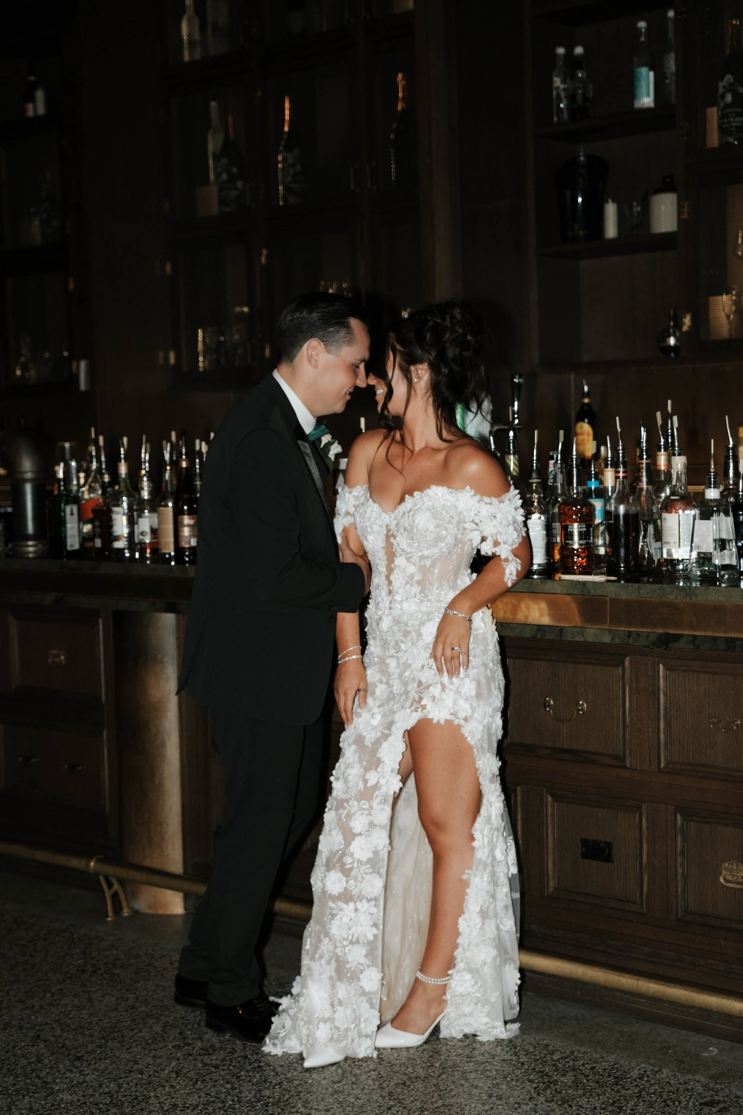 A wedding couple standing close together at the bar during a wedding coordinated by Neesa and Co Events.