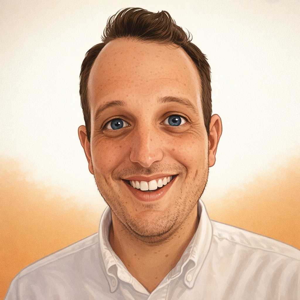 Close-up of a smiling man with light skin, blue eyes, and dark brown hair, wearing a white shirt against a plain white background.
