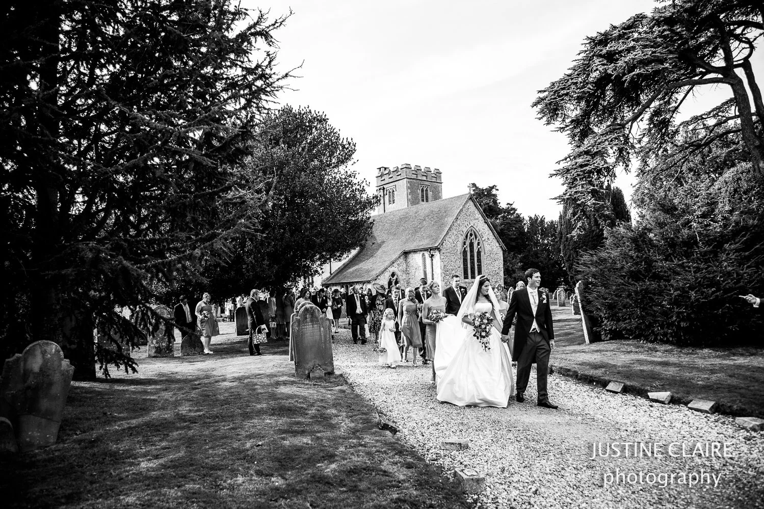 Marquee wedding photographer - farm weddings and lots of hay bales outside church in Bosham