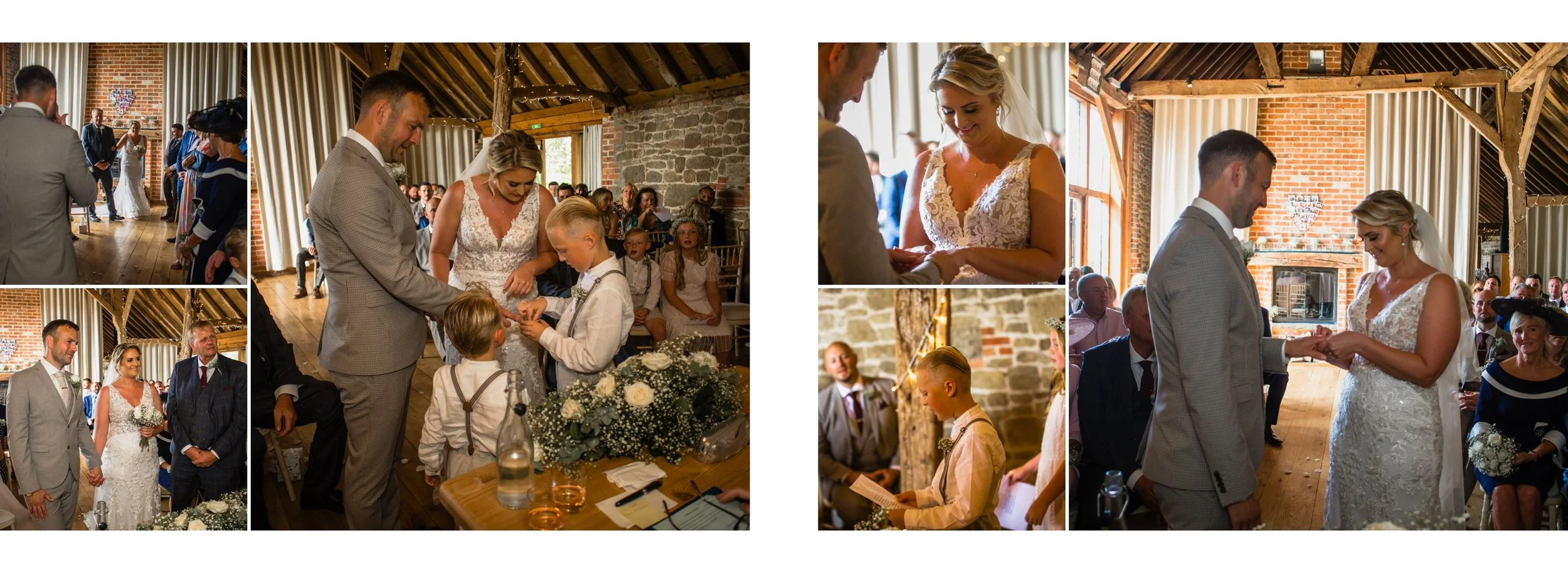 A wedding ceremony inside a rustic barn venue in Tillington with exposed brick and wooden beams, where the bride and groom exchange rings, surrounded by guests. Children are part of the event, and a boy is reading from a paper, with floral arrangemen