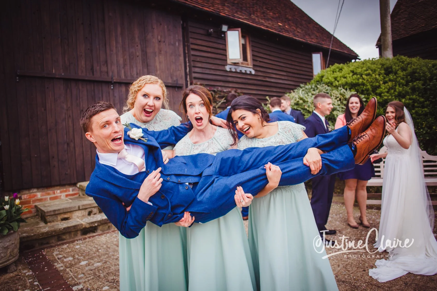 groom being lifted by bridesmaids at Fitzleroi Farm
