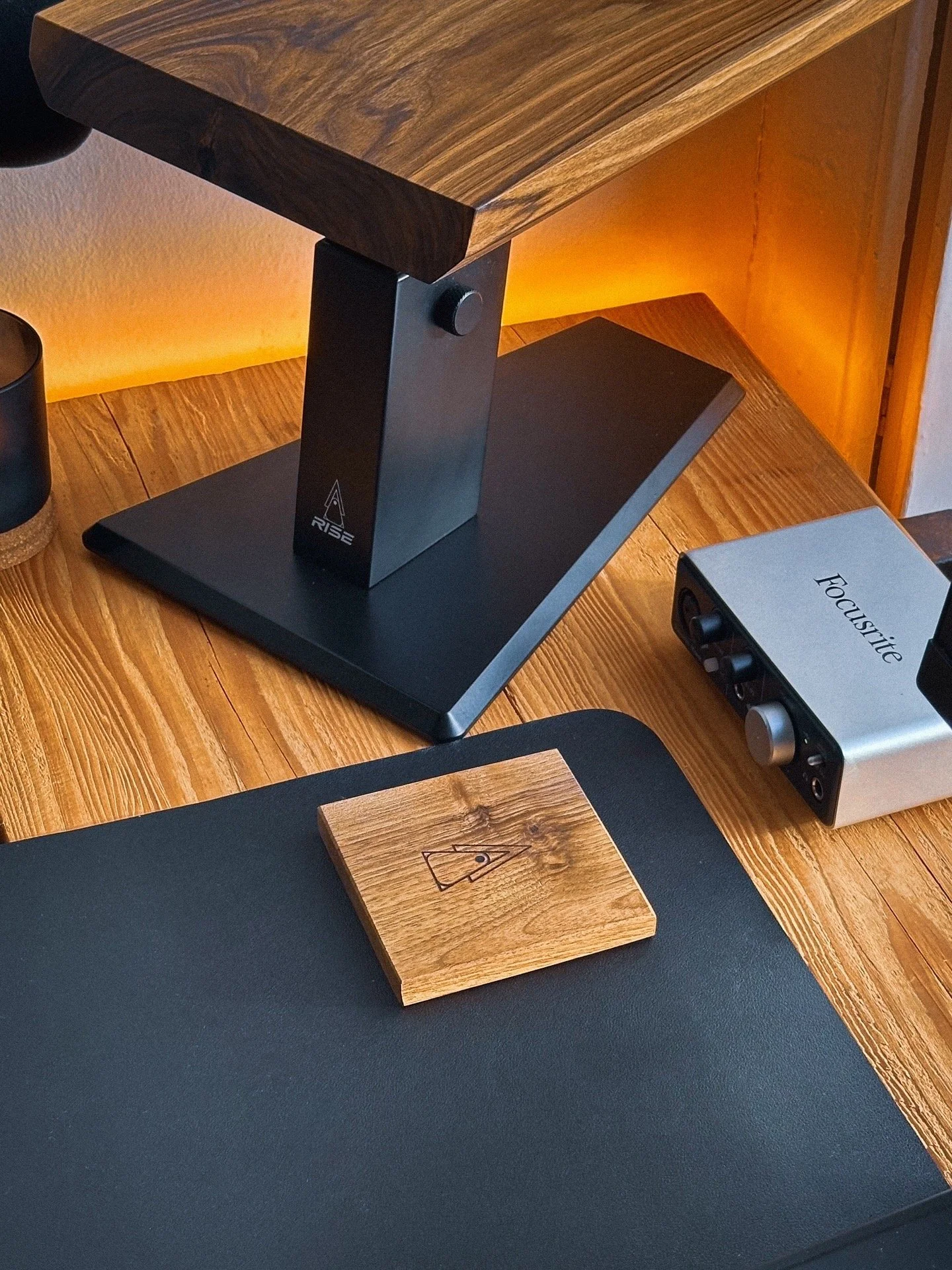 Walnut coaster in a home studio setup with a Rise Audio monitor stand