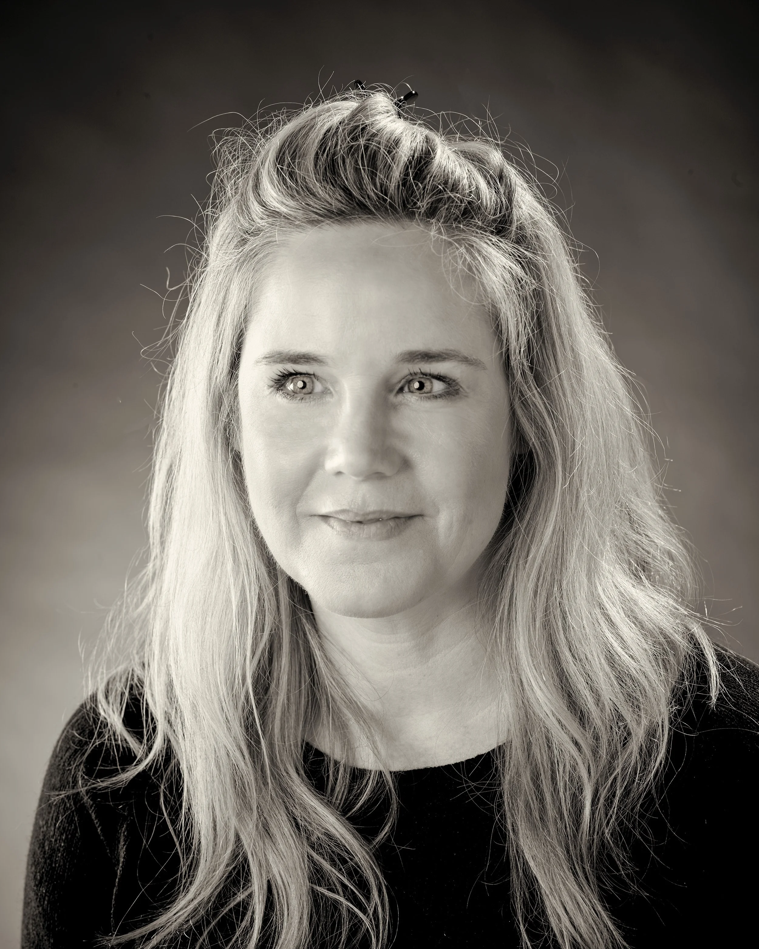 Black and white photograph of Lizzie Ilsley, Operations Manager of White Crow Studios