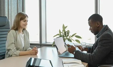 One on One review of Results from Diagnostic Learning - A woman and a man sitting at a conference table in a modern offic