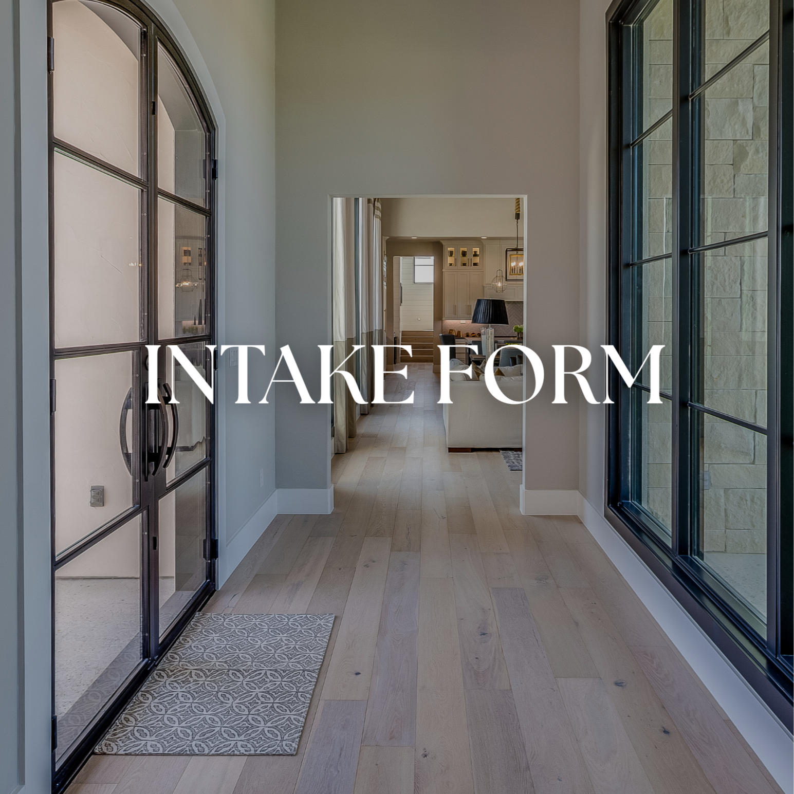 View through a modern home interior with a hallway leading to a living room, featuring large windows, light wood flooring, and a glass door.