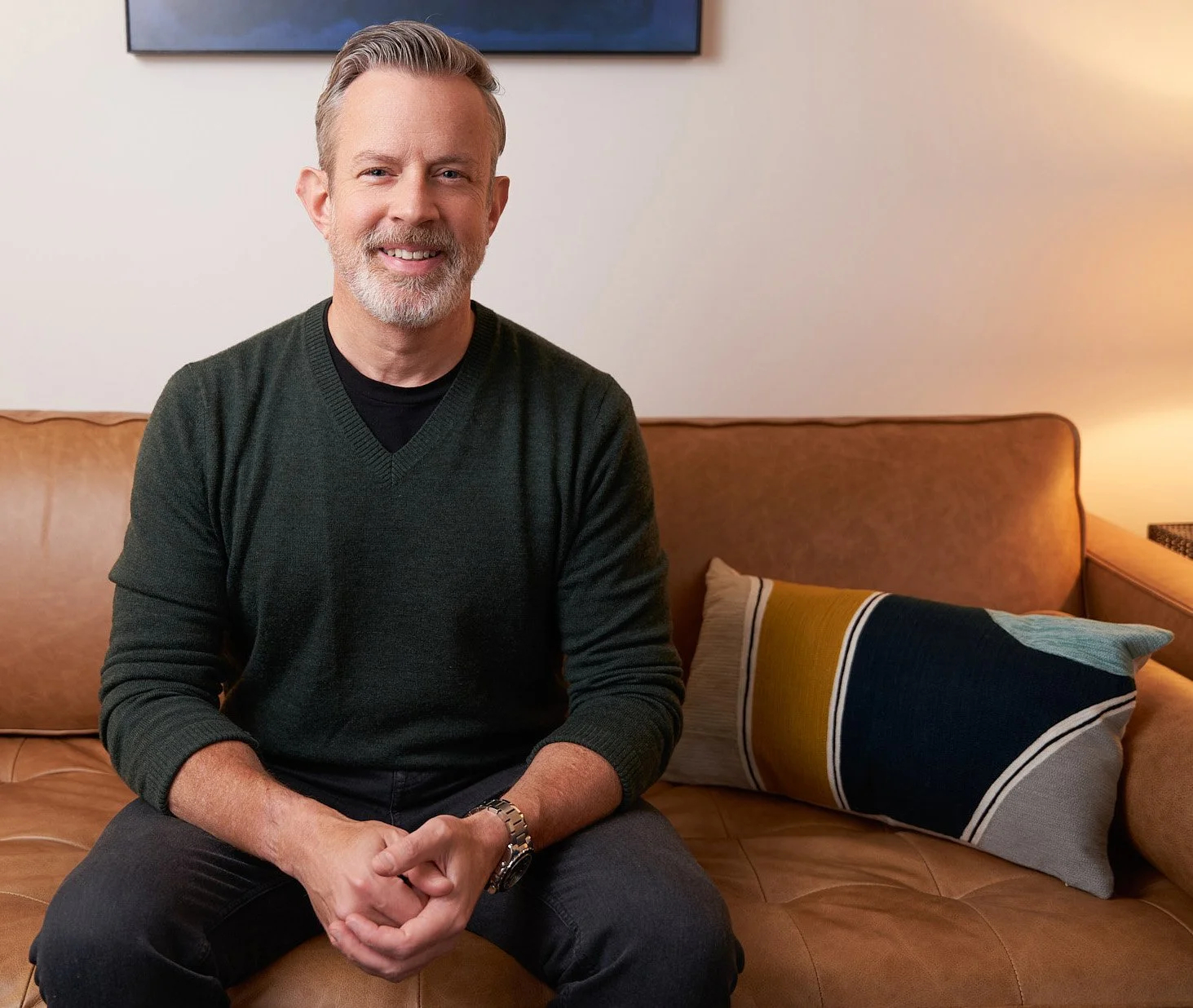 Rivergreen Psychology Group therapist C. Matthew Nichols, PHD smiling and casually sitting on a couch in his office located in the Financial District NYC.