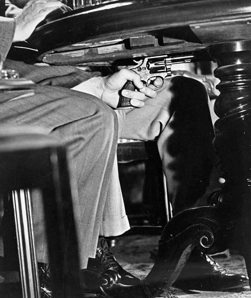 Gun on the table or under it?