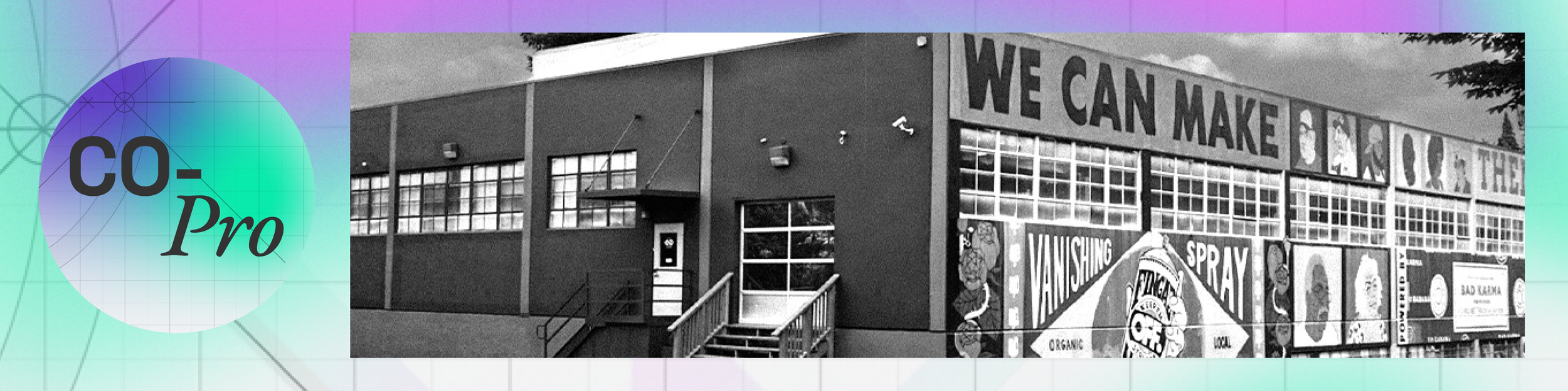Black and white photo of a building with large windows and a mural on the side that reads 'WE CAN MAKE' with illustrations of people's faces and various product advertisements.