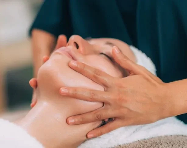Person receiving a facial massage.