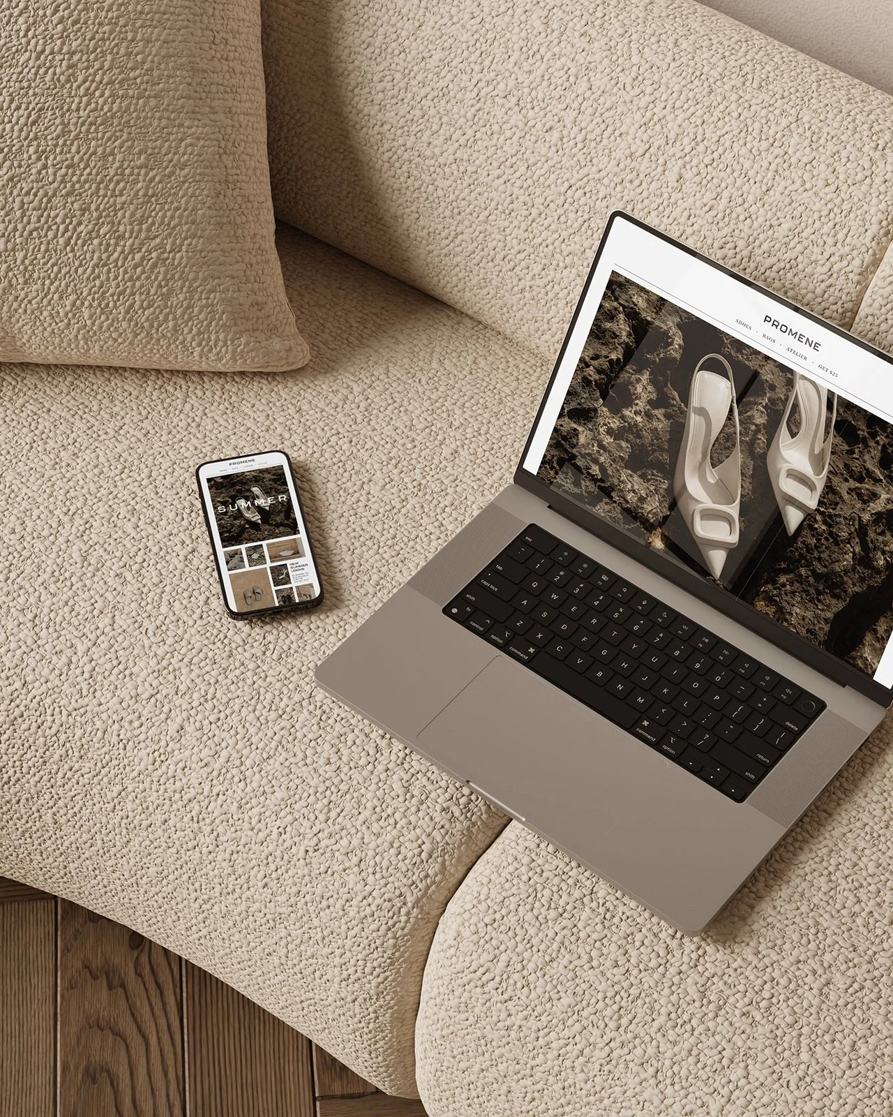 Shopify ecommerce website on a laptop and iphone on a beige sofa.