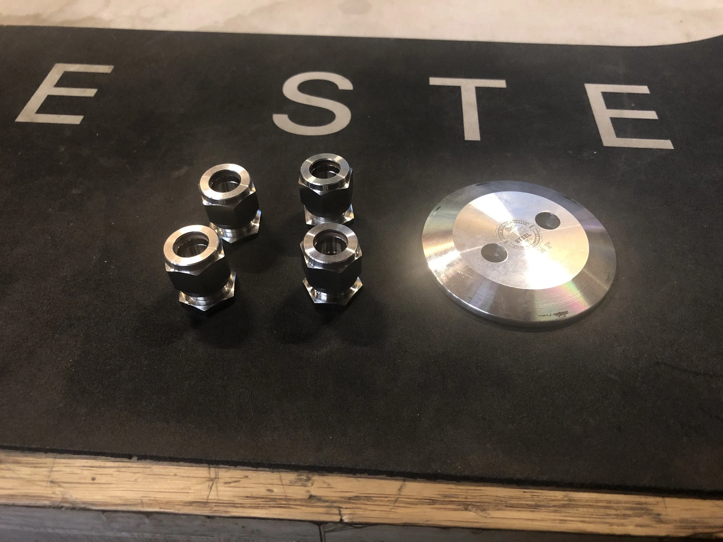 Here is the prototype of the custom adapter. I drilled holes in a 2" tri-clamp flat cap using a drill press. Then I cut 2x 3/8" compression union fittings in half on a band saw. Then I welded the fittings to the flat cap using a TIG welder.