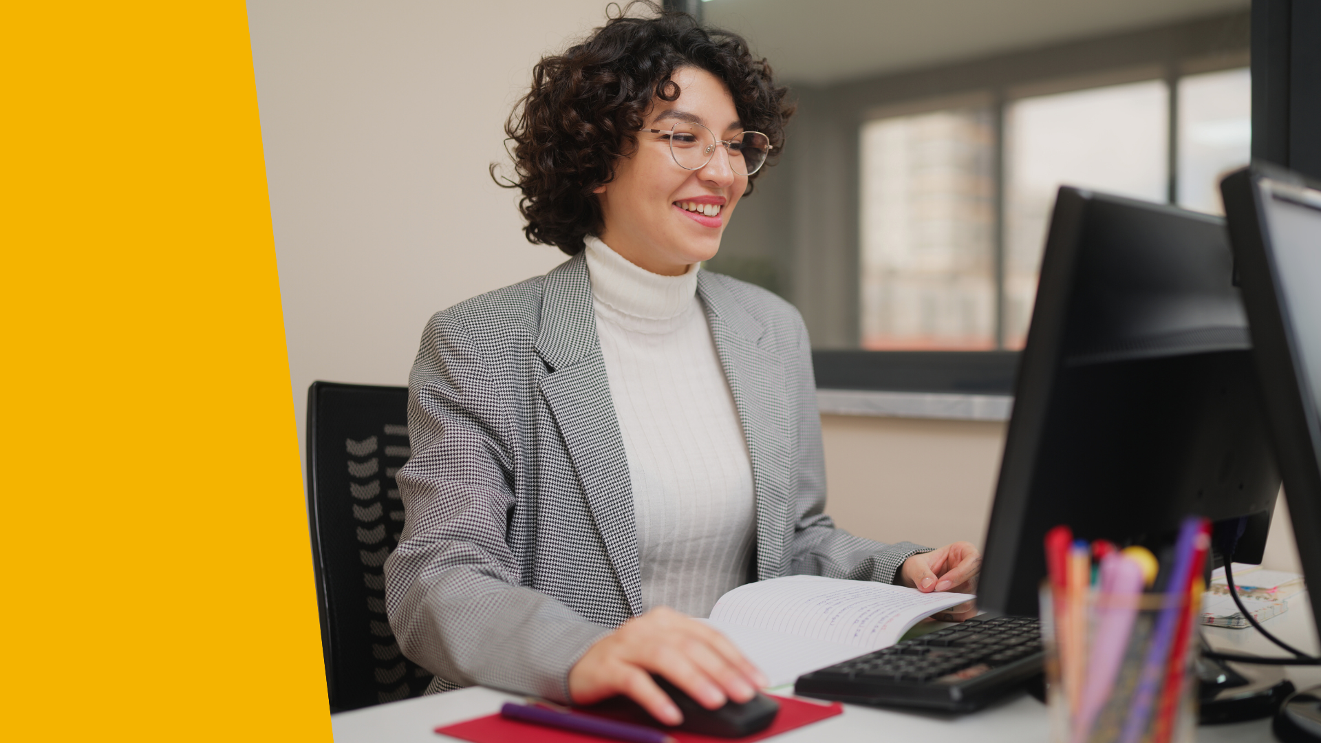 A teacher observes students using laptops