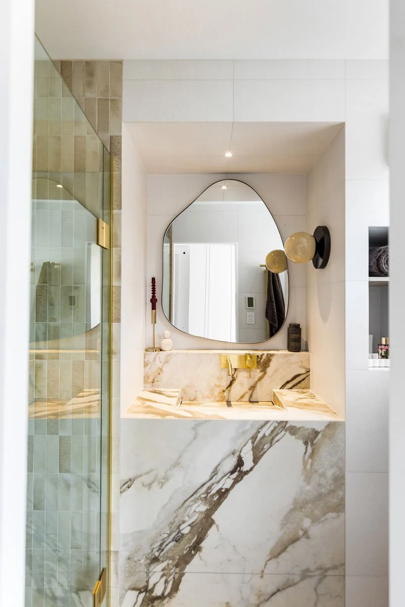 Ze Build bathroom and powder room renovation with brass fixtures and marble tiles