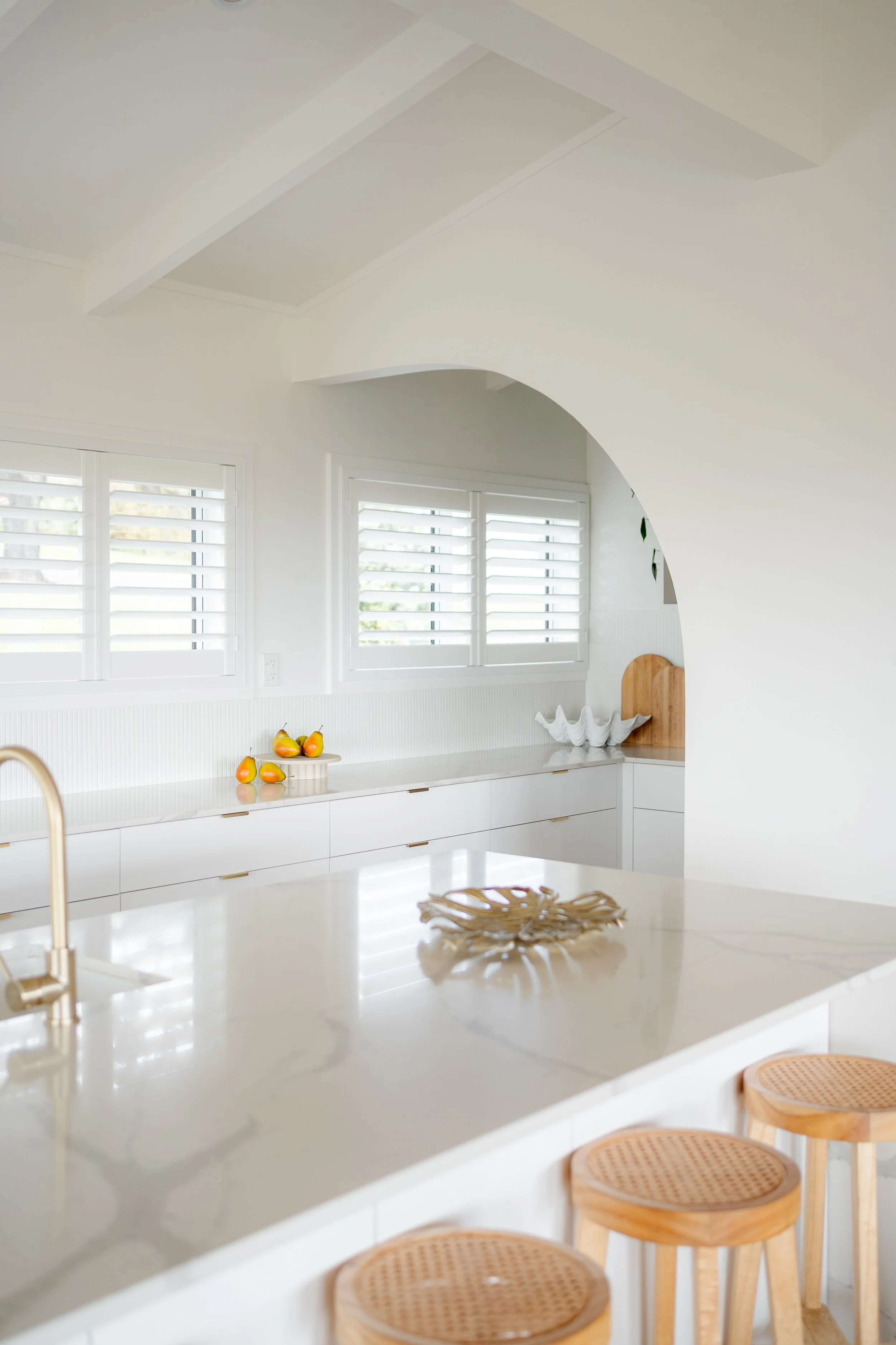 Ach house in Stanmore Bay renovated by Ze Builders with arch details to the butlers kitchen