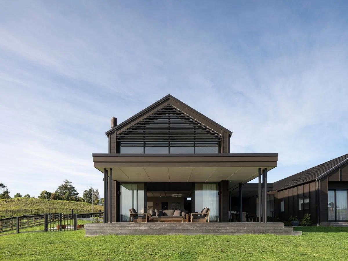 High end archtiectural new build by Ze Build in H shape with gable roof and cedar batten detailing