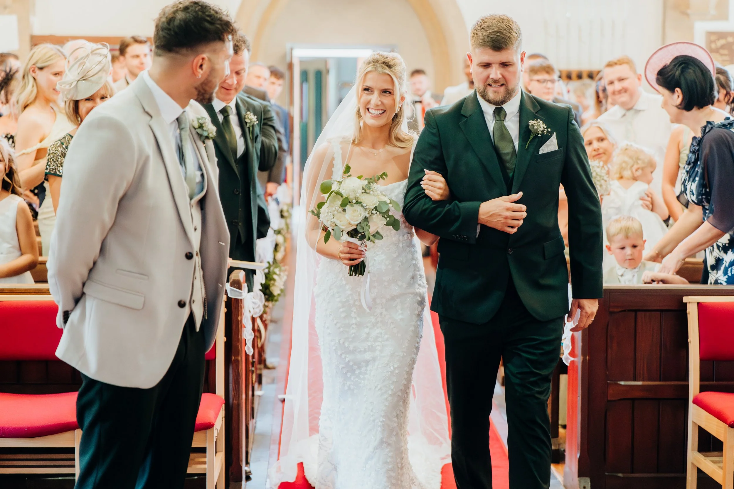 Bride and groom walking back down the aisle together after their wedding ceremony, Surrey