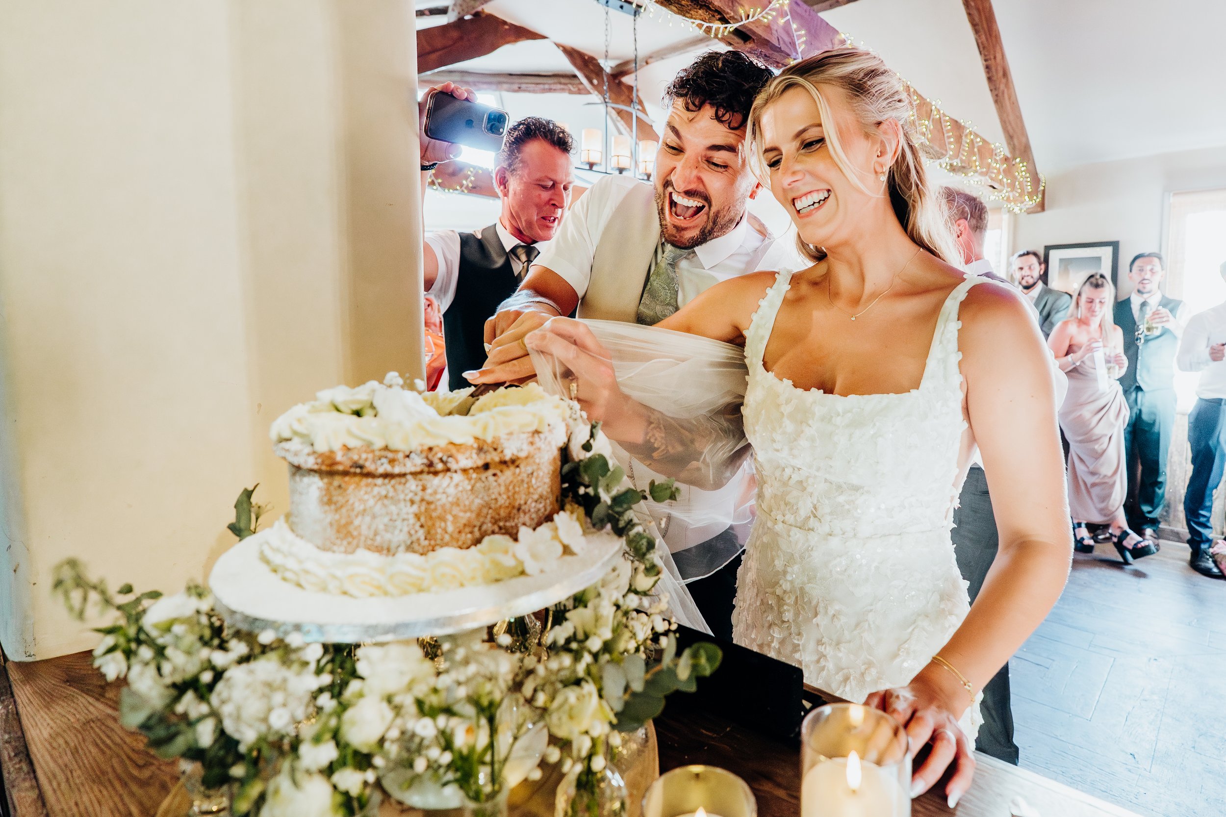 Bride and groom cutting their wedding cake at The Mill at Elstead reception, Surrey
