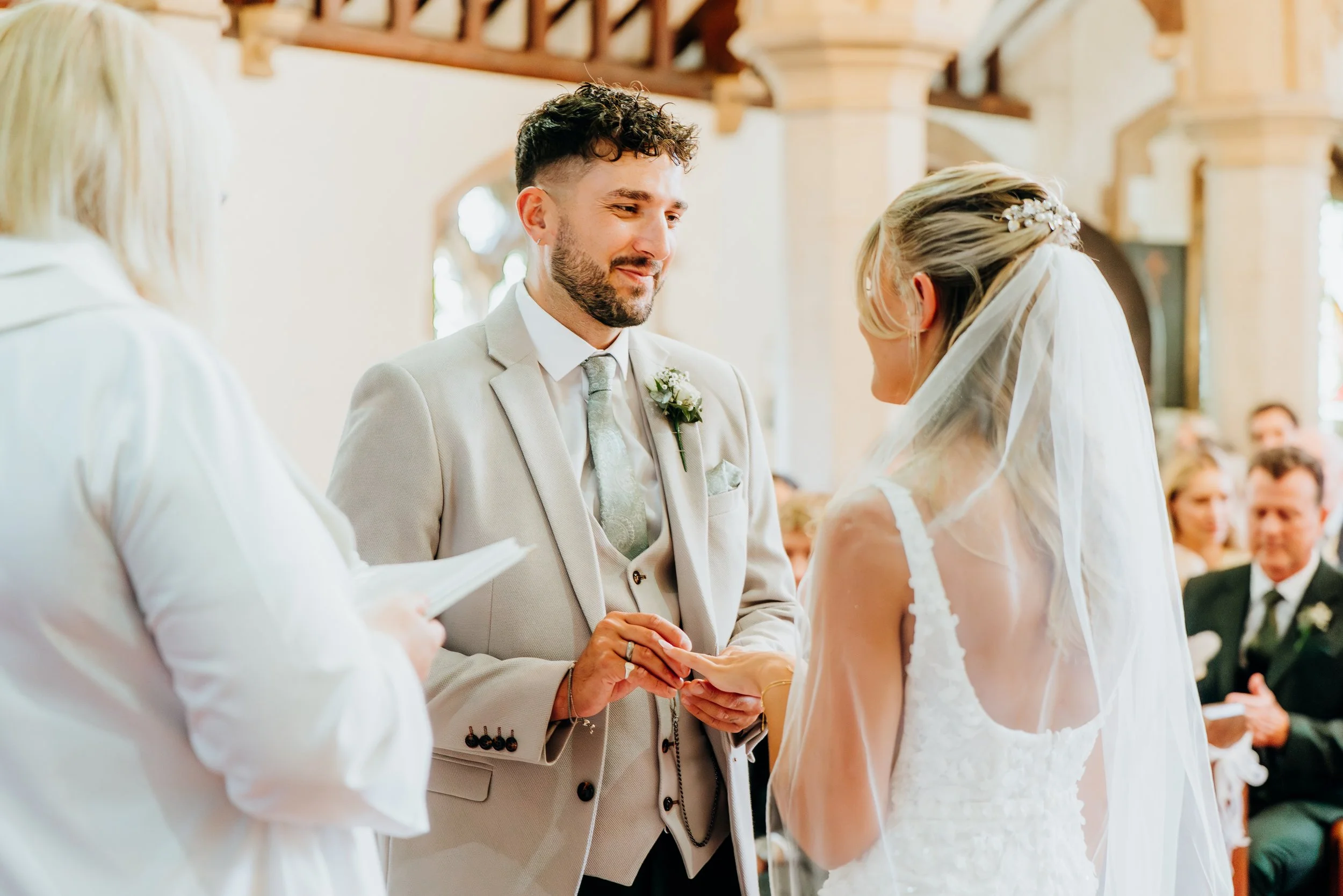 Close-up of wedding ring exchange during ceremony, Surrey wedding photographer