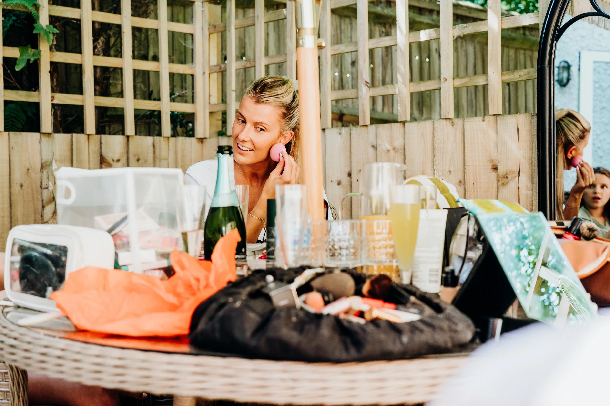 Bride getting ready with drinks and details laid out before her wedding at The Mill at Elstead, Surrey