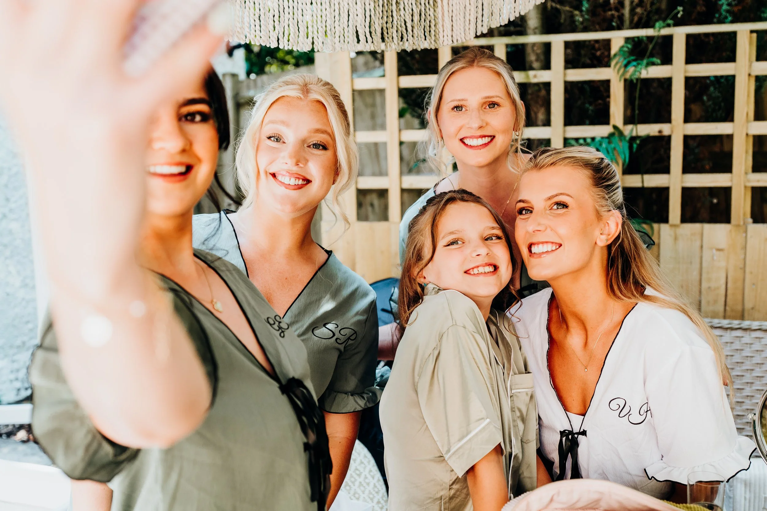 Bridesmaids laughing together while getting ready before the wedding at The Mill at Elstead, Surrey