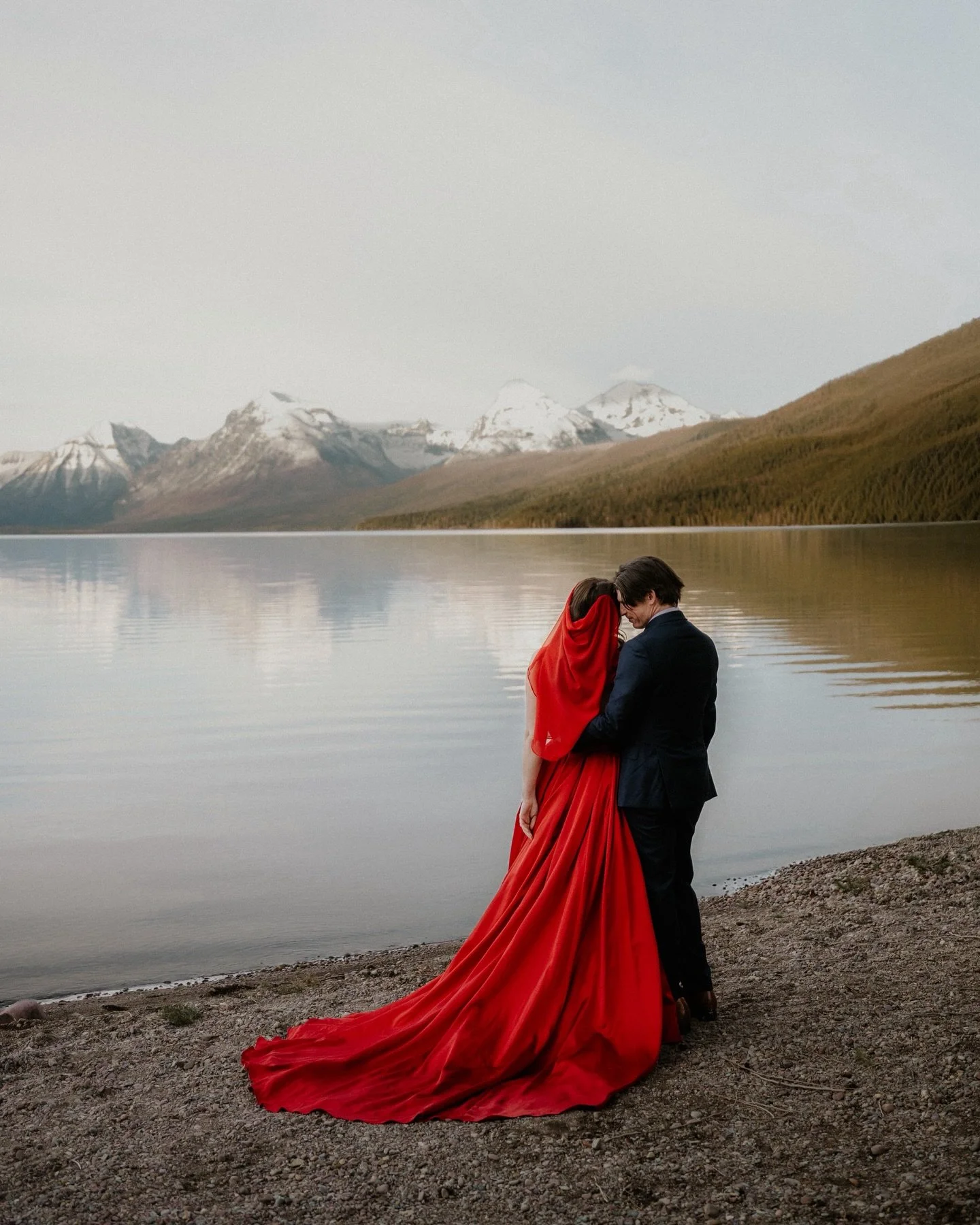 If you&rsquo;re going to elope&hellip; you might as well do it somewhere like this! 

Mountains, glacier water, forest roads, and a red dress that absolutely stole the show 🥹

Days like this are exactly why couples choose Glacier &mdash; simple, bea