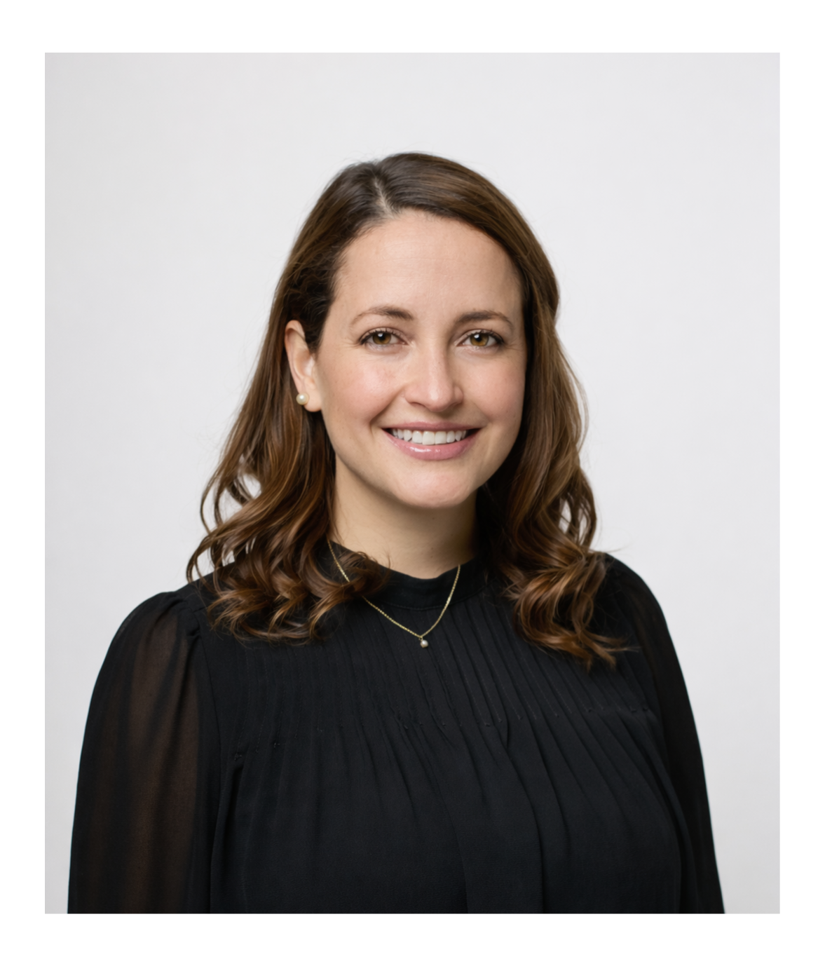 A young man with black hair wearing a black shirt against a black background