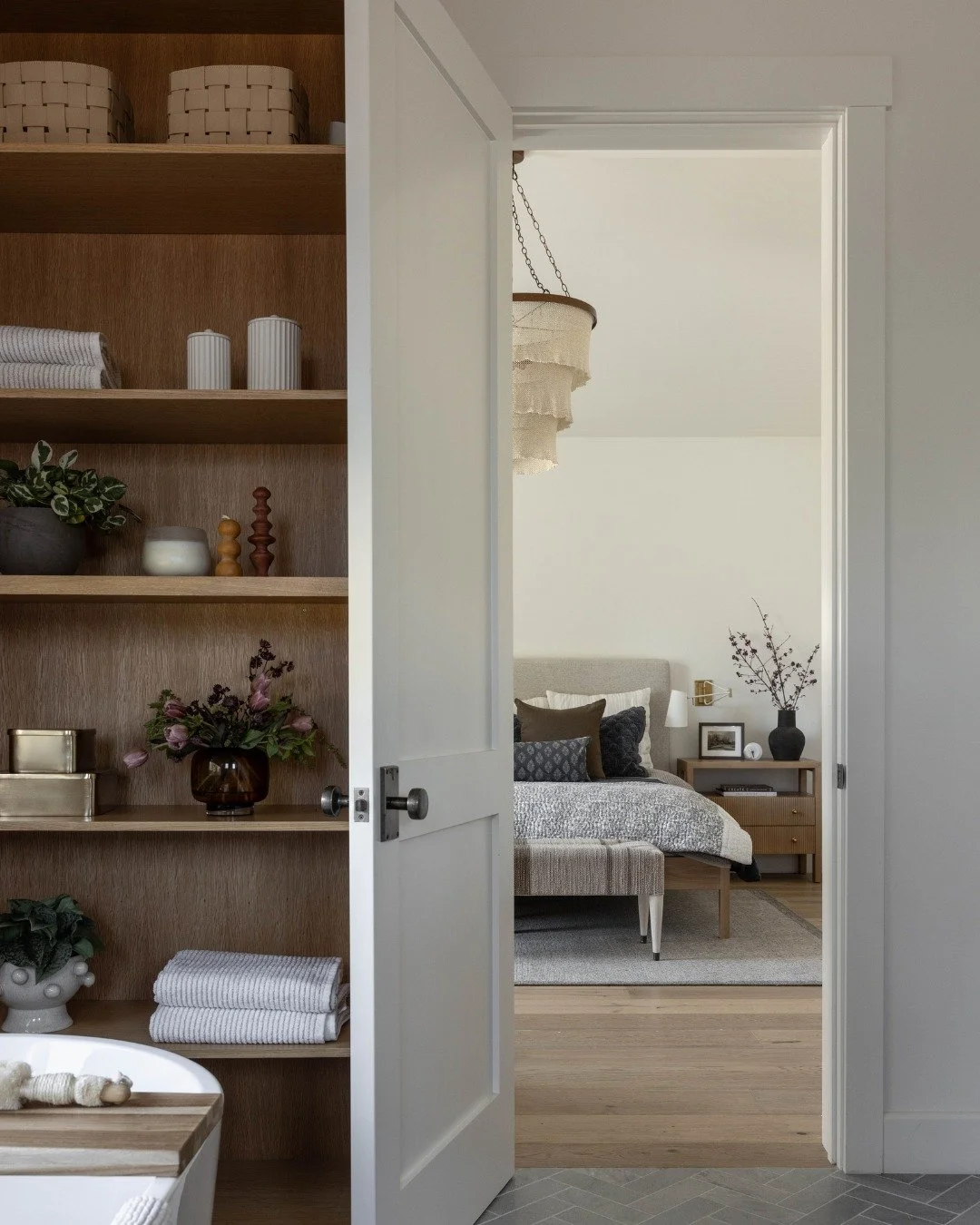 A retreat you might never want to leave. 🛀

The primary suite from our #TimelessSophistication project was designed to feel calm from the moment you walk in. The bedroom and bath flow seamlessly together, with warm wood tones, soft textures, and gen