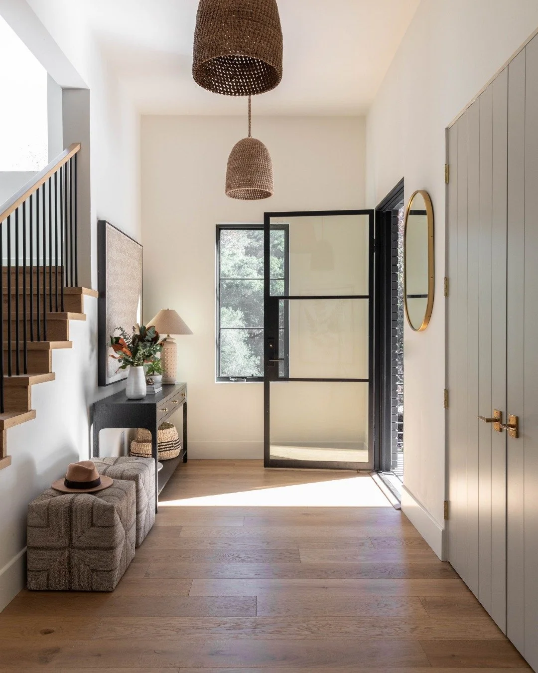 A look inside our #GroundedWarmth project &mdash; a study in organic textures and contrast.

From the moment you step inside, warm wood floors, woven textures, and soft light set the tone. We designed the kitchen to anchor the home with deep black ca