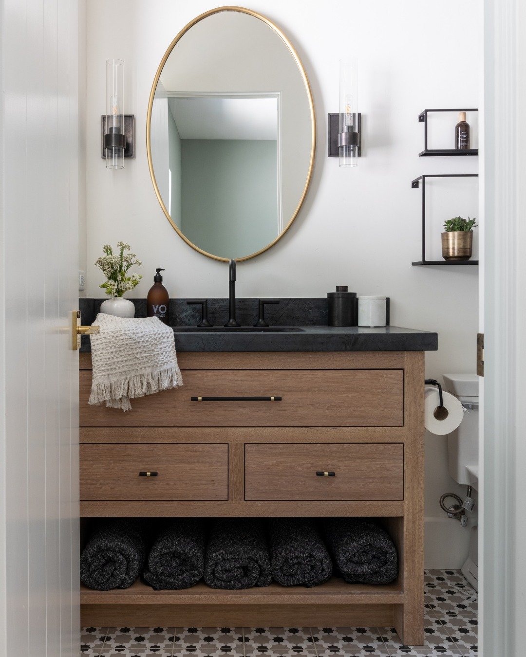 This is your sign to go with the black stone countertops. 🖤

Our #GroundedWarmth powder room was designed to feel earthy and grounding. Warm wood softens the richness of the stone, while patterned tile adds just enough personality to make this small