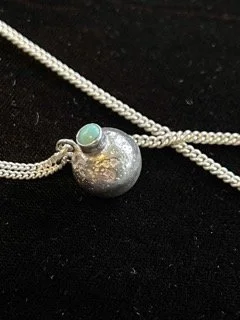 Hand cast silver charm with turquoise setting