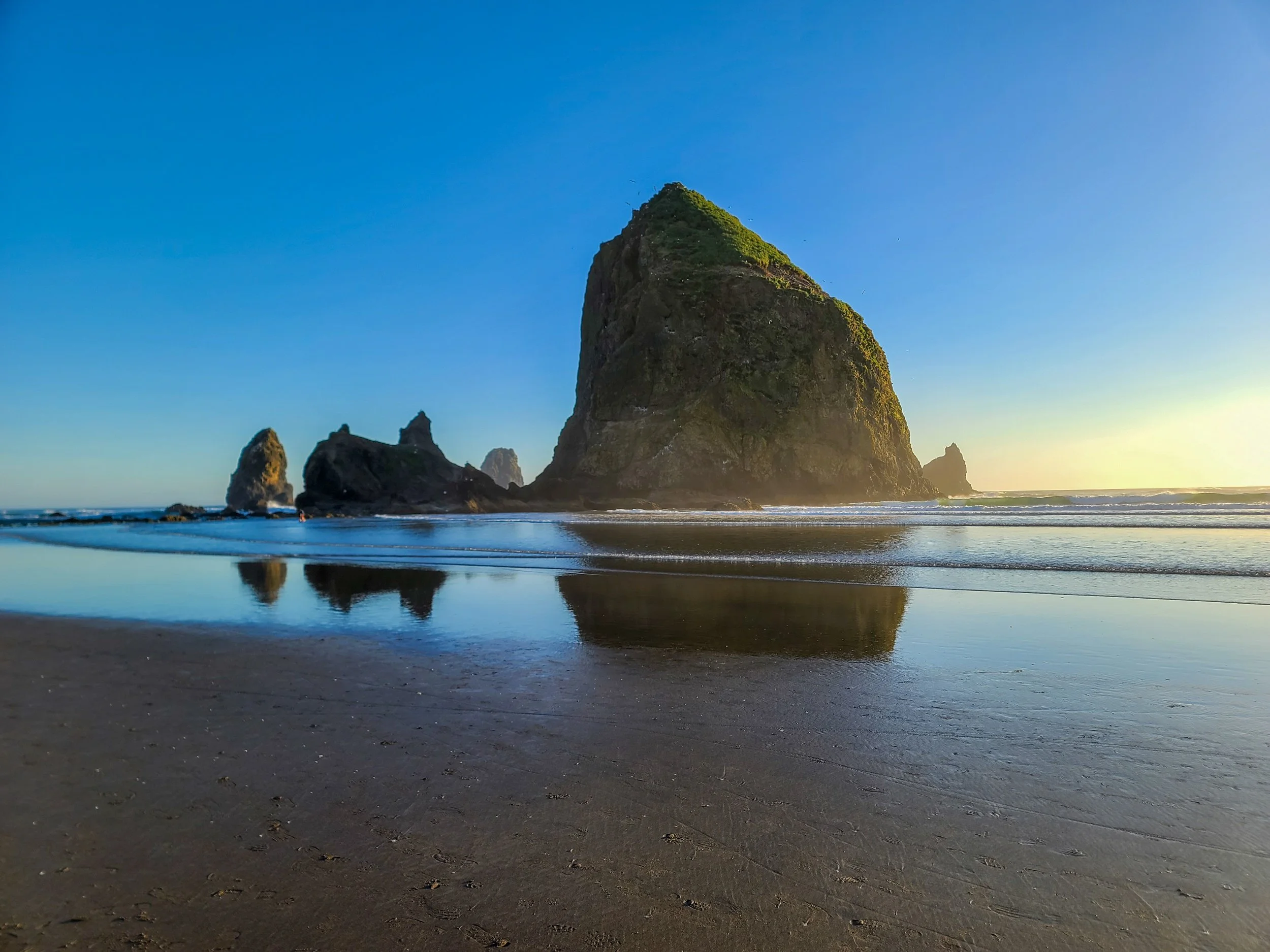 Haystack Rock at sunset, Cannon Beach, Oregon at high tide