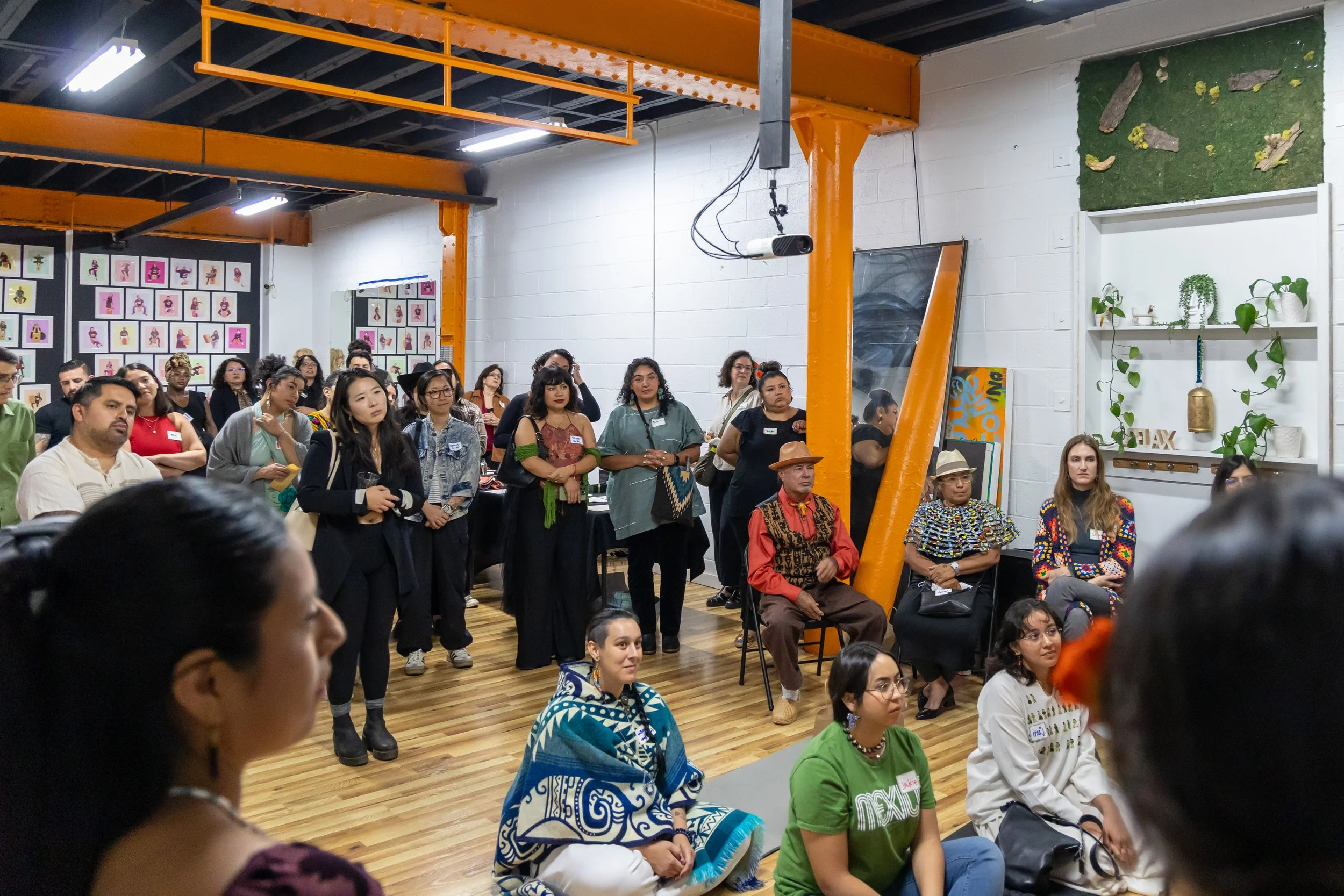 Gala-Guetza guests gather, sit and listen to presentations.