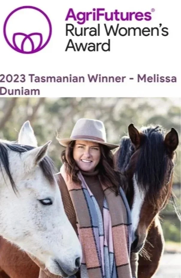 A woman smiling and wearing a hat, standing with two horses outdoors. The top part of the image features the AgriFutures Rural Women's Award logo and text indicating Melissa Duniam as the 2023 Tasmanian winner.
